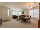 Open-concept living and dining area filled with natural light features neutral walls and plush seating at 170 E Canary Ct, San Tan Valley, AZ 85143