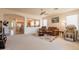 Inviting living room with plush seating, a ceiling fan, and an open flow to the kitchen at 170 E Canary Ct, San Tan Valley, AZ 85143