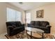 Comfortable living room with two sofas, a glass coffee table, and bright natural lighting at 170 E Canary Ct, San Tan Valley, AZ 85143