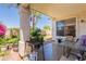 Charming covered patio with outdoor grill, surrounded by lush garden and a clear blue sky backdrop at 170 E Canary Ct, San Tan Valley, AZ 85143