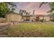 Beautiful backyard with a covered patio, lush greenery, and flowering trees at 1708 E Westchester Dr, Tempe, AZ 85283