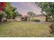 Backyard featuring lush green grass and blooming plants at 1708 E Westchester Dr, Tempe, AZ 85283