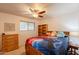 Bedroom features a ceiling fan, dresser, and a comfortable bed at 1708 E Westchester Dr, Tempe, AZ 85283