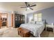 Comfortable bedroom with a ceiling fan, blue walls, and a spacious walk-in closet at 1708 E Westchester Dr, Tempe, AZ 85283
