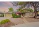 Charming single-story home featuring a landscaped front yard with mature trees and vibrant flowering bushes at 1708 E Westchester Dr, Tempe, AZ 85283