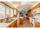 Spacious kitchen featuring stainless steel appliances, wood cabinets, tile floors and an open view into the living room at 1708 E Westchester Dr, Tempe, AZ 85283