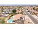 Home aerial view featuring a pool, patio furniture, tile roof, and some solar panels in a suburban neighborhood at 1744 E Fremont Rd, Phoenix, AZ 85042