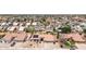 Aerial view of homes featuring tile roofs, driveways, desert landscaping, and some solar panels in a suburban neighborhood at 1744 E Fremont Rd, Phoenix, AZ 85042