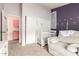 Charming bedroom with purple accents, a crib and a comfortable chair with a ceiling fan at 1744 E Fremont Rd, Phoenix, AZ 85042