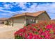 Charming home featuring a two car garage with flowering landscaping in the front yard at 1744 E Fremont Rd, Phoenix, AZ 85042