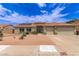 Charming home featuring a three car garage and a well-manicured front yard with desert landscaping and solar panels at 1744 E Fremont Rd, Phoenix, AZ 85042