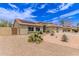 Charming home featuring a three car garage and a well-manicured front yard with desert landscaping and solar panels at 1744 E Fremont Rd, Phoenix, AZ 85042