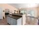 Kitchen island overlooks a large dining area with access to the backyard through sliding glass doors at 1744 E Fremont Rd, Phoenix, AZ 85042