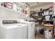 Functional laundry room with shelving, washer, and dryer for convenience at 1744 E Fremont Rd, Phoenix, AZ 85042