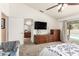 Cozy bedroom features a large dresser, TV, and access to the ensuite bathroom and pool at 1744 E Fremont Rd, Phoenix, AZ 85042