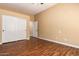 Bedroom featuring laminate wood flooring and a large closet with sliding doors at 18650 N 91St Ave # 3301, Peoria, AZ 85382