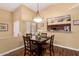 Cozy dining area featuring a dark wood table and seating for four, complemented by natural light from the window at 18650 N 91St Ave # 3301, Peoria, AZ 85382