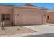 Tan home featuring a two car garage, desert landscaping and a tile roof at 18650 N 91St Ave # 3301, Peoria, AZ 85382