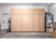 Spacious garage featuring built-in storage cabinets and a hot water tank at 18650 N 91St Ave # 3301, Peoria, AZ 85382