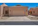 Tan home featuring a two car garage, desert landscaping and a tile roof at 18650 N 91St Ave # 3301, Peoria, AZ 85382
