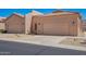 Tan homes featuring two car garages, desert landscaping and tile roofs at 18650 N 91St Ave # 3301, Peoria, AZ 85382