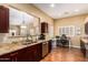 Modern kitchen with granite countertops, stainless steel appliances, and an open view to an office and living space at 18650 N 91St Ave # 3301, Peoria, AZ 85382