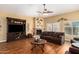 Comfortable living room with cozy seating, fireplace, ceiling fan, and laminate flooring at 18650 N 91St Ave # 3301, Peoria, AZ 85382