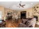 Inviting living room with cozy seating, fireplace, ceiling fan, and laminate flooring at 18650 N 91St Ave # 3301, Peoria, AZ 85382