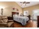 Serene main bedroom featuring a king-sized bed, high ceilings, and a ceiling fan for optimal comfort at 18650 N 91St Ave # 3301, Peoria, AZ 85382
