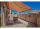 Inviting outdoor patio with awning, decorative wall art, and comfortable seating at 18650 N 91St Ave # 3301, Peoria, AZ 85382