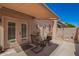 Outdoor patio featuring a retractable awning, stucco walls, and comfortable seating, ideal for relaxing at 18650 N 91St Ave # 3301, Peoria, AZ 85382