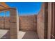 Enclosed outdoor patio area with privacy walls under a bright blue sky at 18650 N 91St Ave # 3301, Peoria, AZ 85382