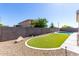 Fenced backyard with lush artificial turf and a sparkling pool for outdoor enjoyment at 18675 W Foothill Dr, Surprise, AZ 85387