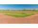 Baseball field, with lush green grass and a well-maintained clay infield at 18675 W Foothill Dr, Surprise, AZ 85387