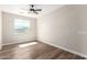 Bedroom with wood flooring, ceiling fan, and natural light from the window at 18675 W Foothill Dr, Surprise, AZ 85387