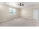 Comfortable carpeted bedroom with natural light from the window and a ceiling fan at 18675 W Foothill Dr, Surprise, AZ 85387