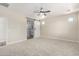 Bright bedroom with a ceiling fan and a view to a bathroom through a sliding barn door at 18675 W Foothill Dr, Surprise, AZ 85387