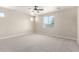 Spacious bedroom featuring a large window and a ceiling fan at 18675 W Foothill Dr, Surprise, AZ 85387