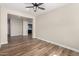 Open-concept living room with wood flooring and access to a kitchen area at 18675 W Foothill Dr, Surprise, AZ 85387