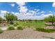 Lush park with mature trees, green grass, benches, and walking paths at 18675 W Foothill Dr, Surprise, AZ 85387