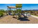 Community playground featuring play structure, slides, and mulch ground cover at 18675 W Foothill Dr, Surprise, AZ 85387