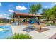 Community playground features covered slides, benches, and play areas, perfect for recreation at 18675 W Foothill Dr, Surprise, AZ 85387
