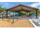 Covered playground featuring slides, swings, and picnic tables offers a shaded recreational area at 18675 W Foothill Dr, Surprise, AZ 85387