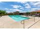 Community pool with lounge areas and well-maintained deck, perfect for relaxation and recreation at 18675 W Foothill Dr, Surprise, AZ 85387