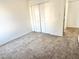 Bedroom features neutral walls and carpet with closet and interior access at 1927 E Hampton Ave # 260, Mesa, AZ 85204
