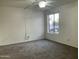 Bedroom featuring neutral carpet, a ceiling fan, and a view to the outside at 1927 E Hampton Ave # 260, Mesa, AZ 85204
