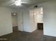 Bright bedroom with a ceiling fan, carpet floors, and access to the bathroom at 1927 E Hampton Ave # 260, Mesa, AZ 85204