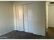 Bedroom with built-in closet doors and new carpeting at 1927 E Hampton Ave # 260, Mesa, AZ 85204