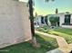 Inviting community common area with lush green lawn, mature trees, and picnic tables near the swimming pool at 1927 E Hampton Ave # 260, Mesa, AZ 85204