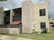 Inviting condo building featuring private balconies, secure fencing, and well-manicured lawn at 1927 E Hampton Ave # 260, Mesa, AZ 85204